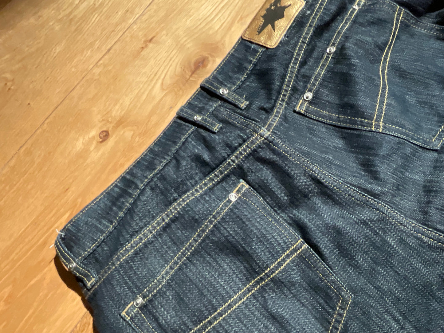 “STUDDED RAW DENIM”